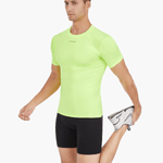 Side view of the Men’s UVTee Lightweight Baselayer in neon yellow, with the model stretching, highlighting its ergonomic fit, moisture-wicking fabric, and athletic design for rowers.