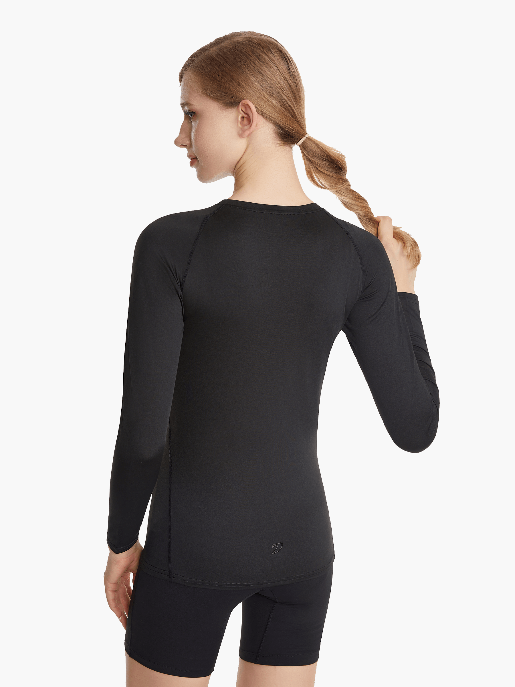 Angled back view of the SolarShield UVTee Long Sleeve for Ladies in black, emphasizing seamless construction and advanced UV-blocking technology for performance on and off the water.