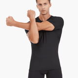 Front view of the Men’s UVTee Lightweight Baselayer in black, with the model stretching, highlighting the moisture-wicking fabric, flatlock stitching, and athletic fit designed for rowers.
