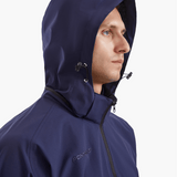 Close-up of the SprayShield Pro Rowing Jacket’s hood in navy, showcasing the fold-away design and toggle adjustments for added protection against the elements