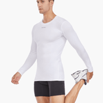 Side view of the Men’s UVTee Long Sleeve Baselayer in white, with the model stretching, highlighting its flexibility, lightweight construction, and suitability for rowing training sessions.