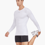 Side view of the Men’s UVTee Long Sleeve Baselayer in white, with the model stretching, highlighting its flexibility, lightweight construction, and suitability for rowing training sessions.
