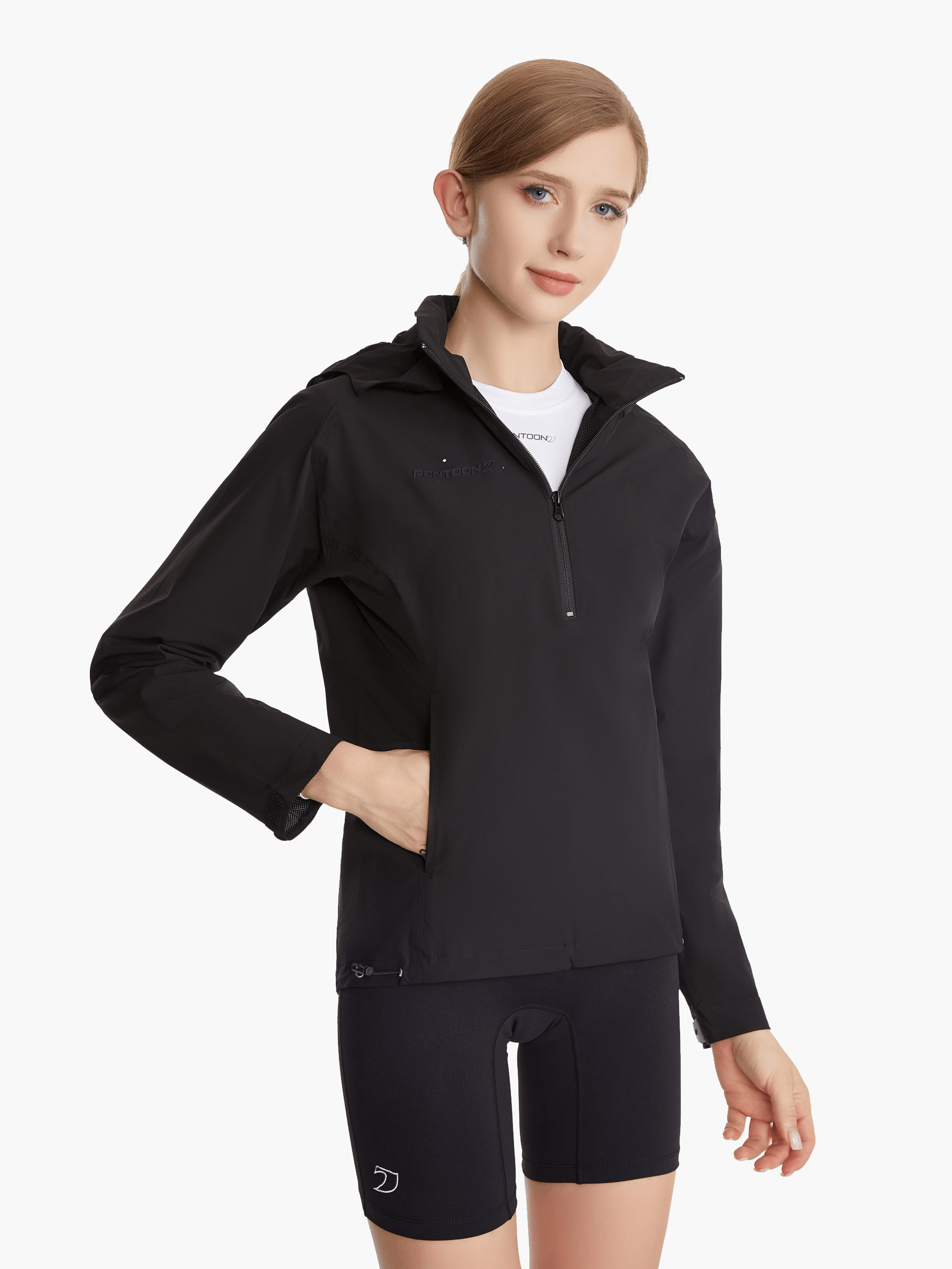 Angled front view of the SprayShield Pro Rowing Jacket in black, showcasing the ergonomic high-cut front and fold-away hood for wind and rain protection during rowing.