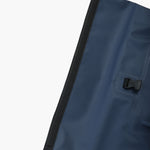 Close-up of the top zipper section of the backpack with a secure flap closure.