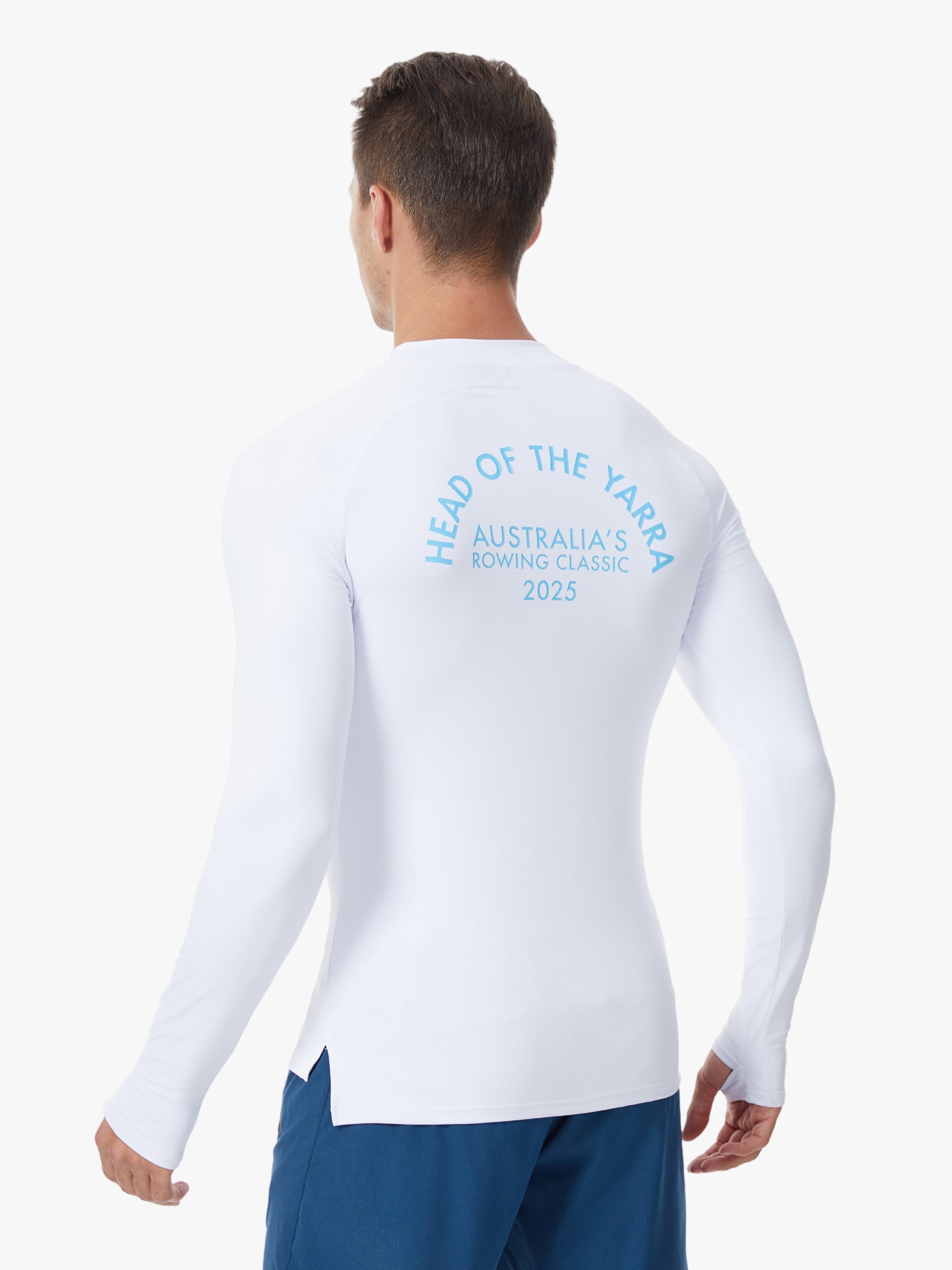 Paul wearing a white long-sleeve UV Tee with head of the yarra 2025 text on the back.