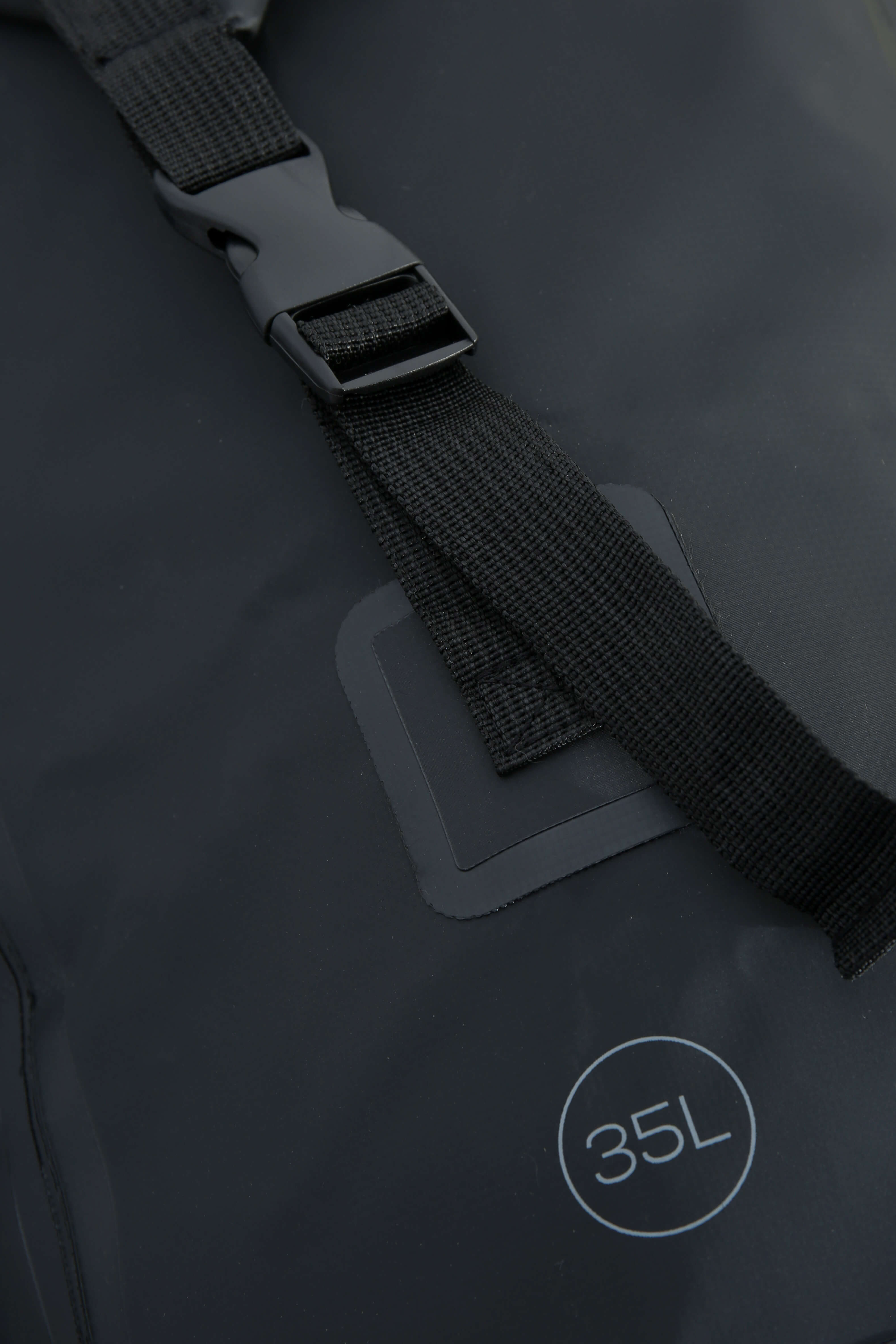 Side strap of the waterproof bag. Close-up of the strap showing the '35L' marking and attachment point detail.